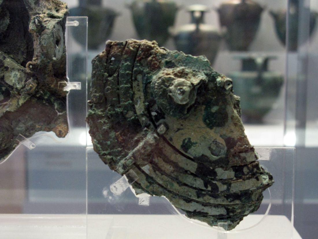Close view of a corroded bronze fragment of the Antikythera mechanism showing the layered edges of its plates