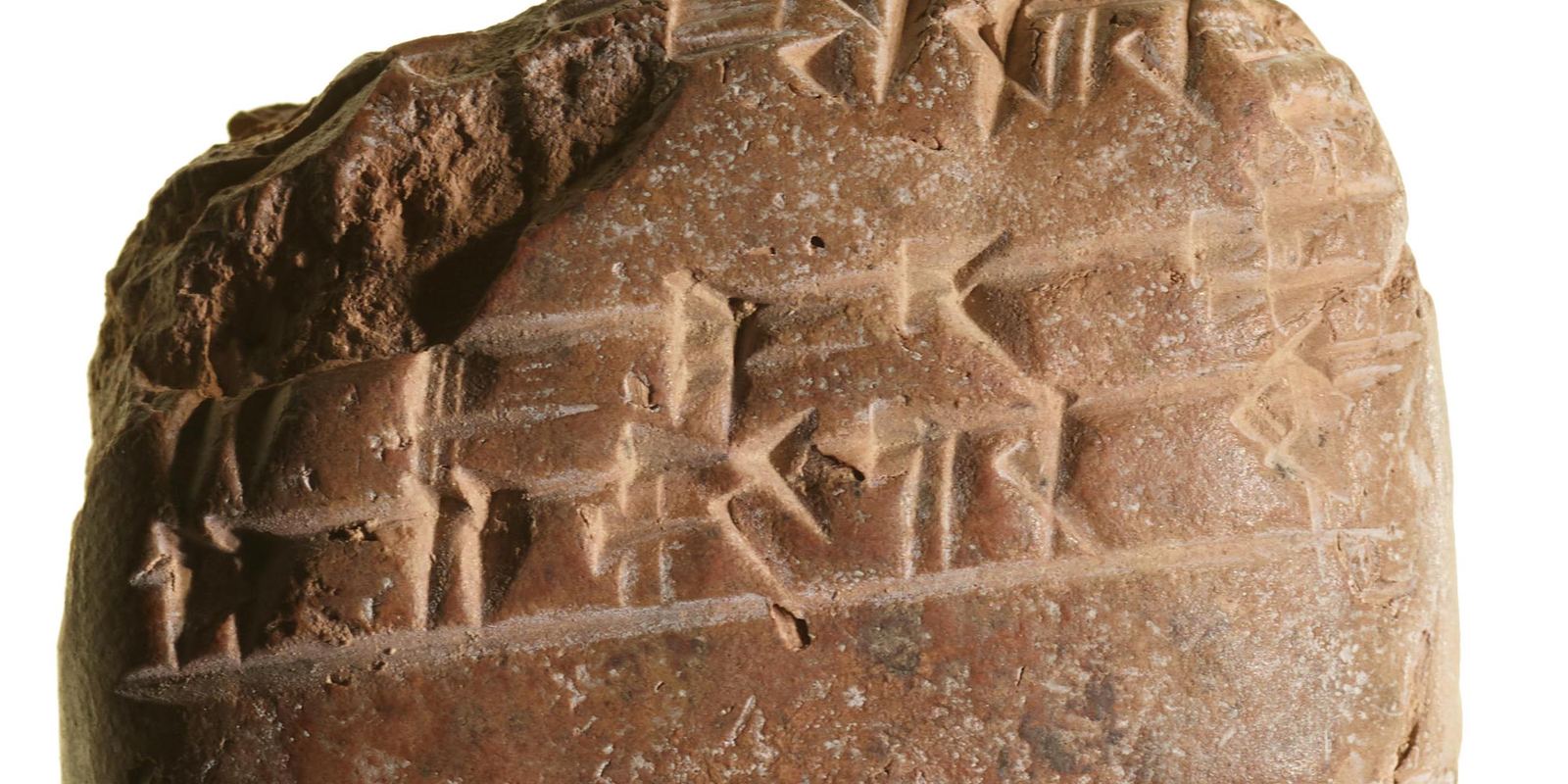 A clay tablet covered in wedge-shaped cuneiform signs